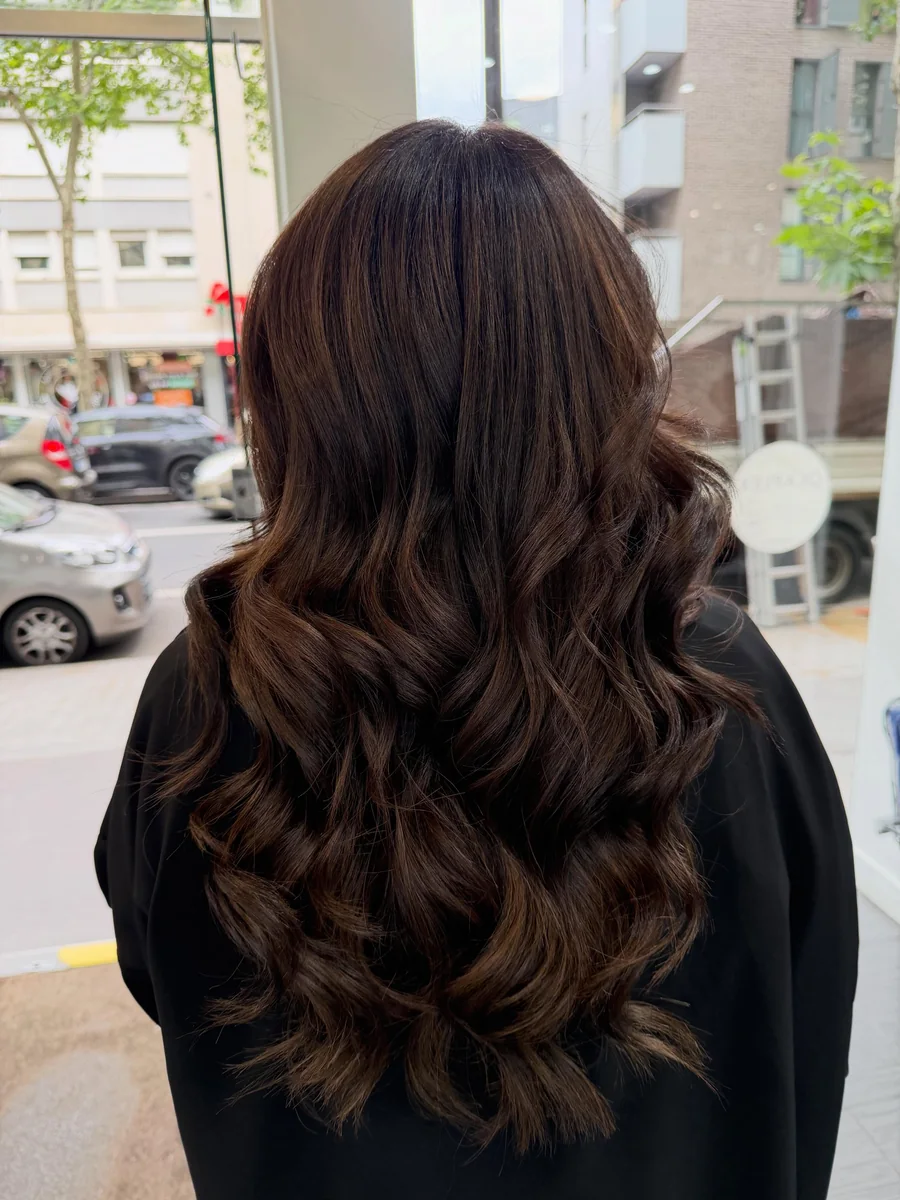 Longs cheveux bruns coiffés en ondulations